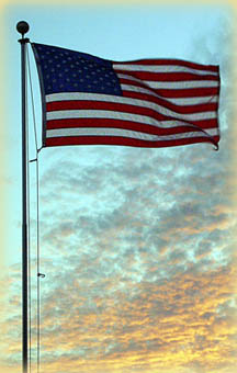 US flag flying just before sunset.